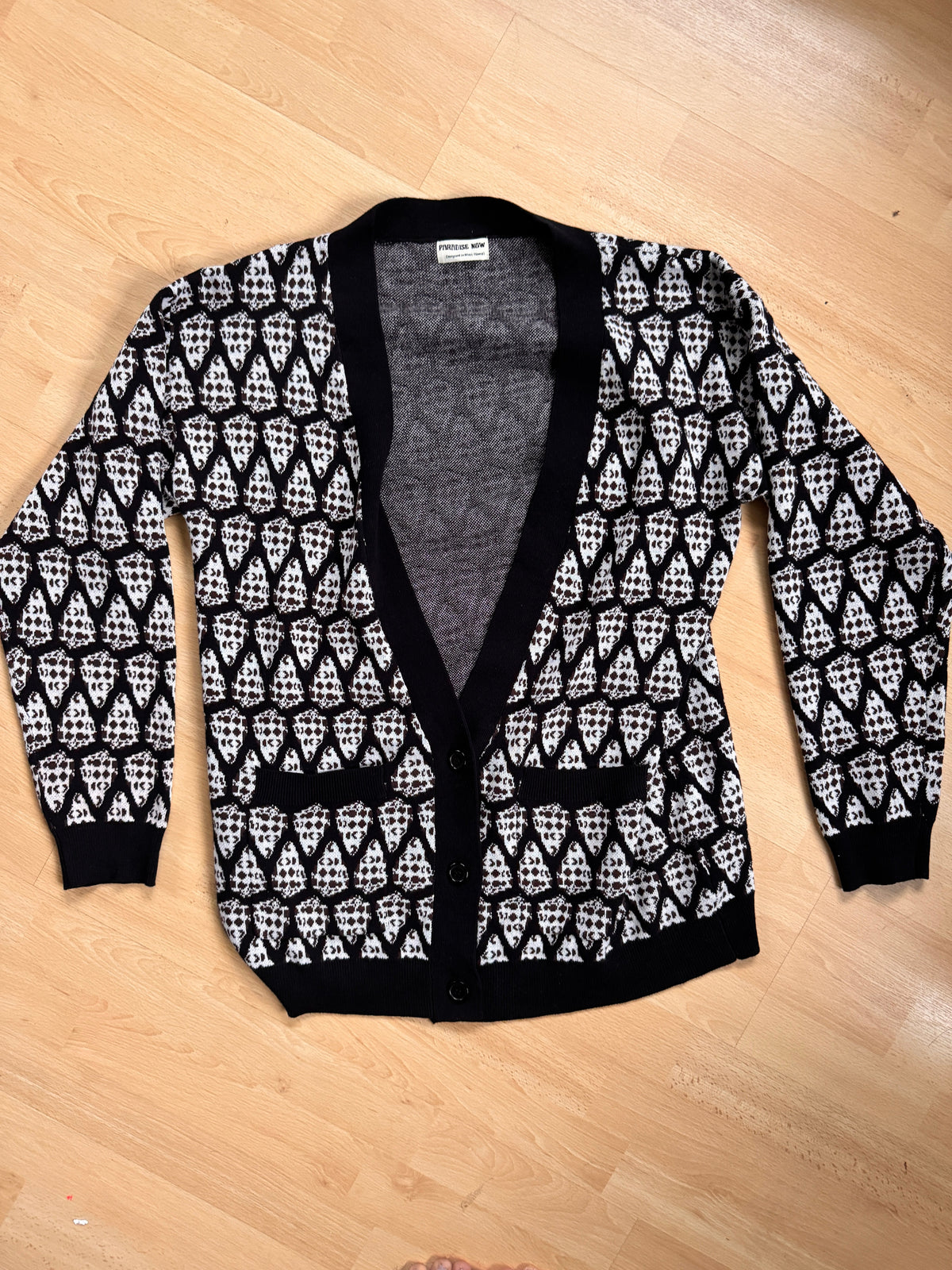 Black and white patterned leggings on a wooden floor