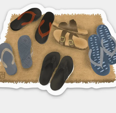 Doormat with various pairs of sandals and flip-flops on a textured surface