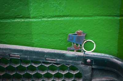 Small model of a cherry picker on a green vehicle grille