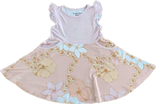 Children's dress with floral skirt on a pink background