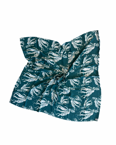 Teal headband with white animal pattern on a teal background