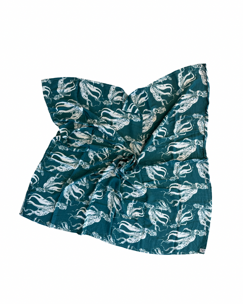 Teal headband with white animal pattern on a teal background