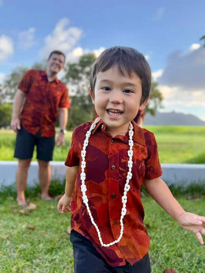 Boys red floral pattern aloha shirt on a red background