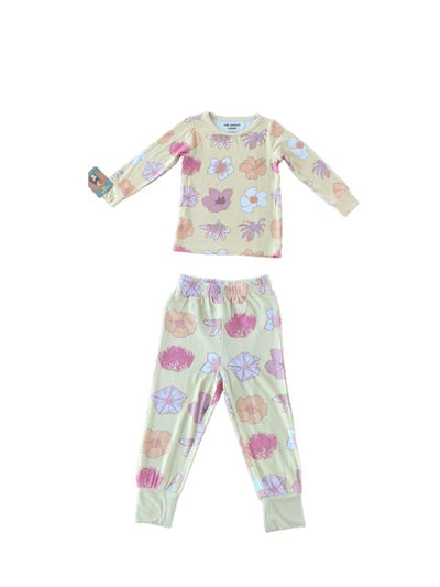 Children's pajama set with floral pattern on a light yellow background