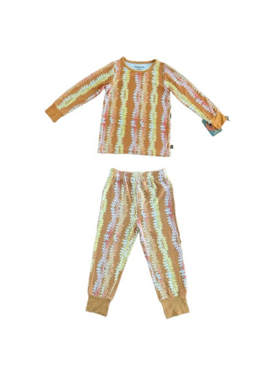 Floral pajama set with long-sleeve top and pants on a mustard burn orange background