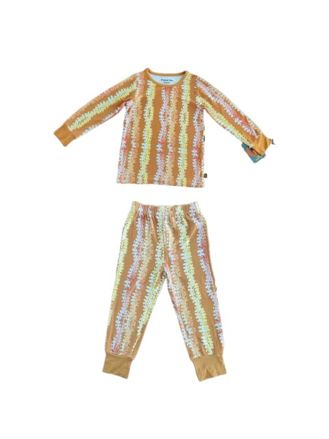 Floral pajama set with long-sleeve top and pants on a mustard burn orange background