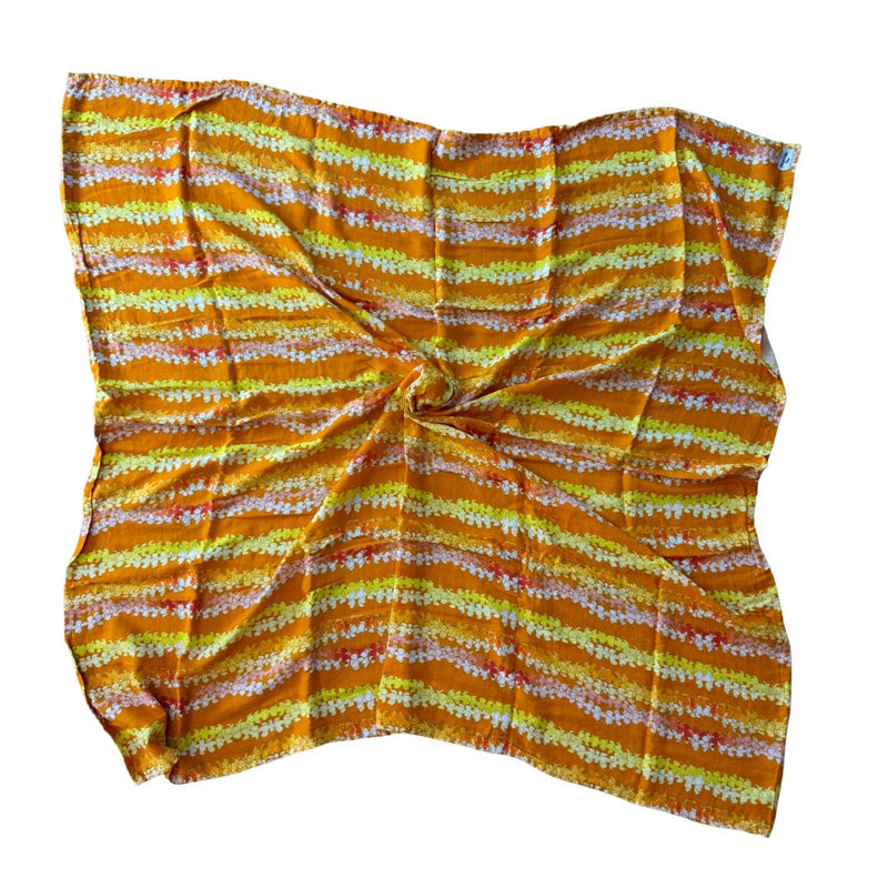 Yellow and orange patterned fabric on a pumpkin color background